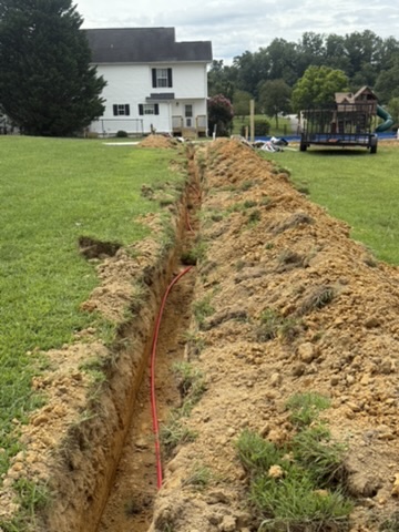 Long utility trench across a residential lawn
